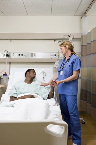 Doctor consoling patient in hospital