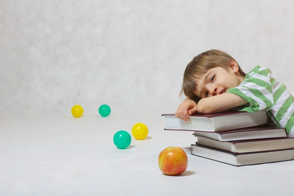 A boy and a pile of books