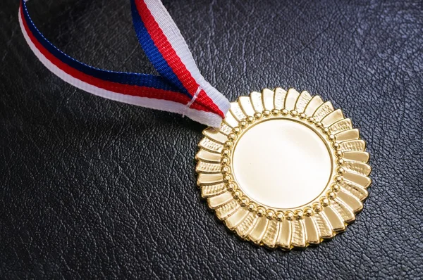 Gold medal - award for a winner on black background.