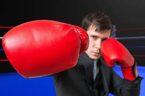 Punch of boxing businessman in suit. Fighting concept.