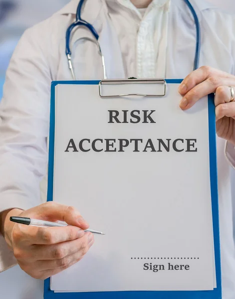 Doctor offers informed consent risk acceptance for signature
