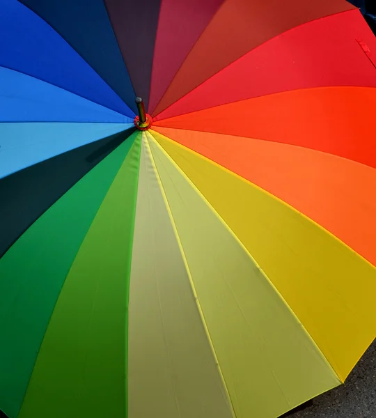 Umbrella with rainbow colors on the pavement