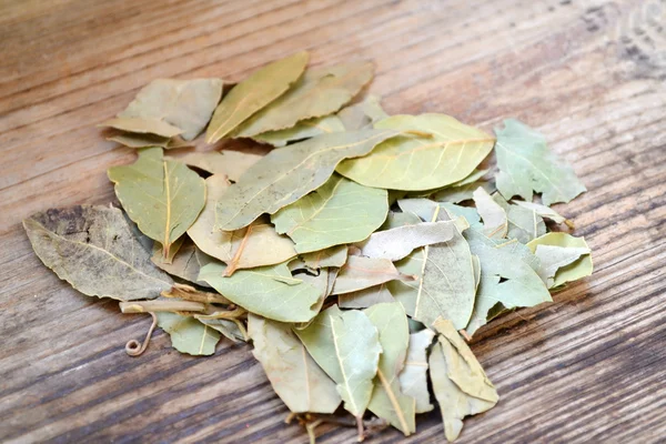 Bunch of dry bay leaves on wooden table