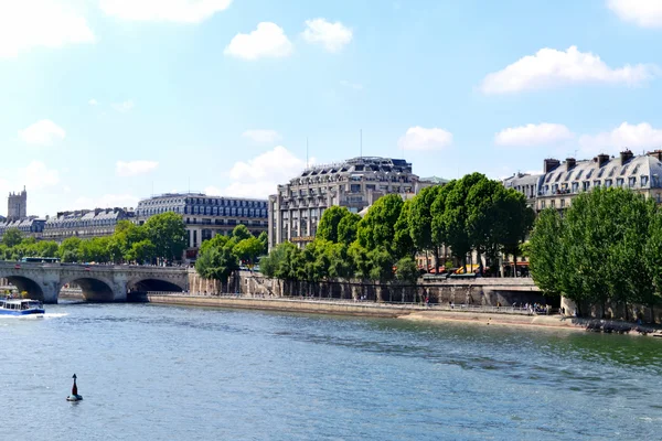 PARIS, FRANCE - 25 MAY, 2015: Rivar Seine over blue sky and cityscape of Paris city