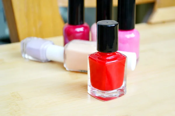 A bottle of red nail polish closeup