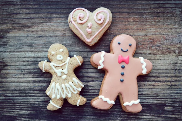 Gingerbread cookies in shape of heart and ginger man on wooden table