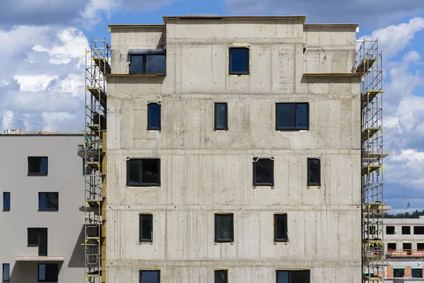 Horizontal photo of house apartment construction site with scaffolding