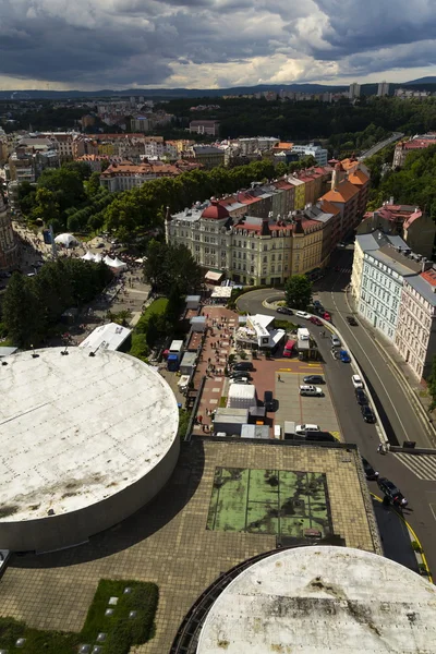 People walk on streets of spa town Karlovy Vary with roof of Hotel Thermal in foreground on July 3, 2016 in Karlovy Vary, Czech republic.