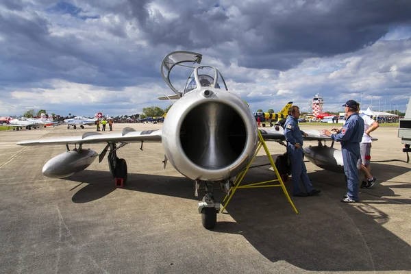 HRADEC KRALOVE, CZECH REPUBLIC - SEPTEMBER 5: Pilot of jet fighter aircraft Mikoyan-Gurevich MiG-15 developed for the Soviet Union standing on runway on September 5, 2015 in Hradec Kralove, Czech repu