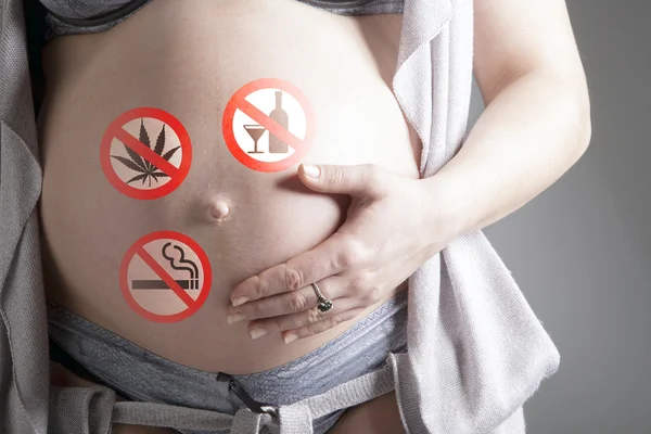 Pregnant woman with sign