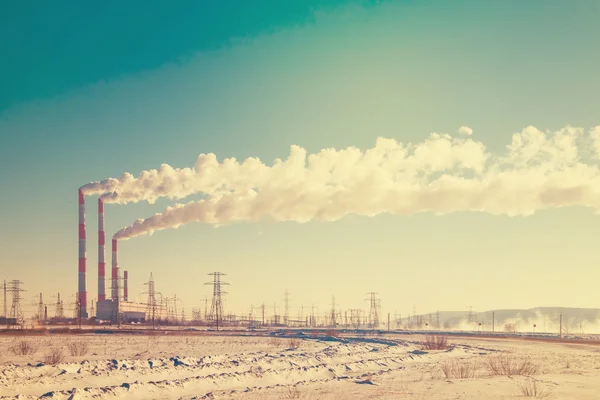 Industrial view of factory pipes with smoke