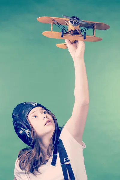 Cute young girl with airplane model