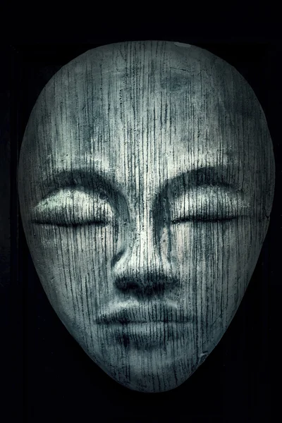 Dark wooden face with eyes