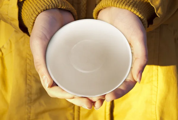 Small dish in hands.