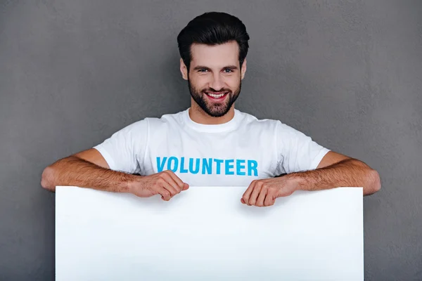 Confident young man in volunteer t-shirt