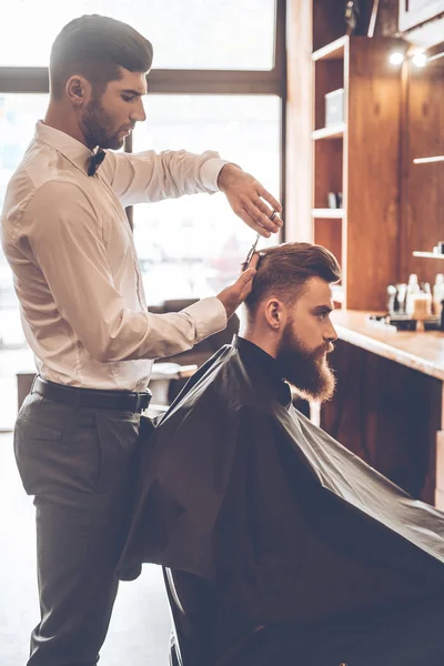 Young bearded man with hairdresser