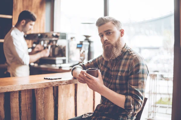 Bearded man with coffee and barista