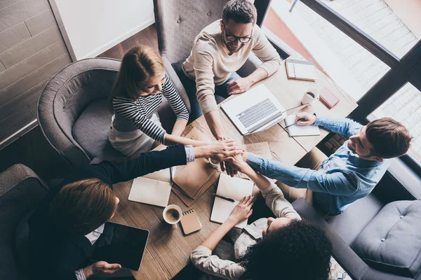 Business people holding hands together