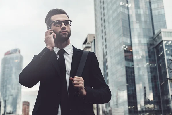 Man in full suit talking on the mobile phone