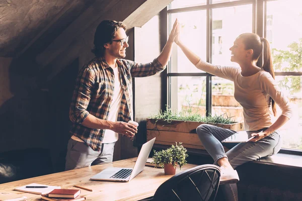 Man and woman giving high-five