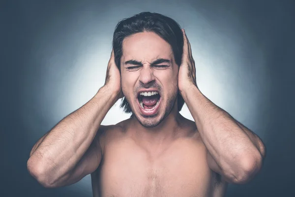 Shirtless man keeping eyes closed