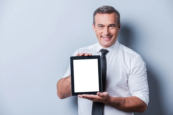 Mature man  showing digital tablet