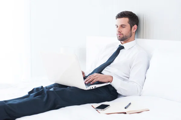 Man in shirt and tie working on laptop