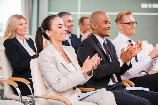 Group of happy business people applauding