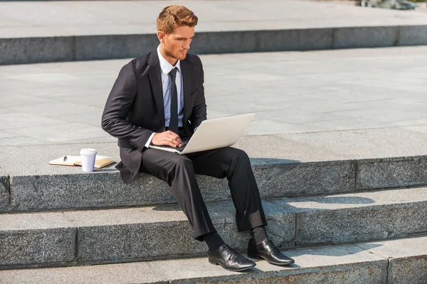 Businessman working outdoors.