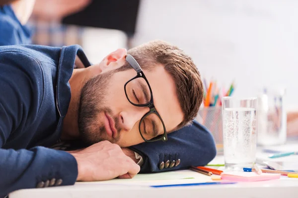 Tired young businessman sleeping