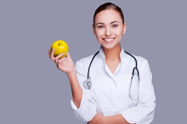 Female doctor holding apple