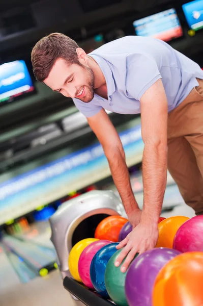 Man choosing bowling ball