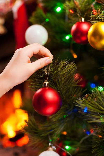 Child decorating Christmas Tree