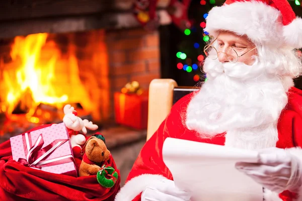 Santa Claus looking at his sack with presents