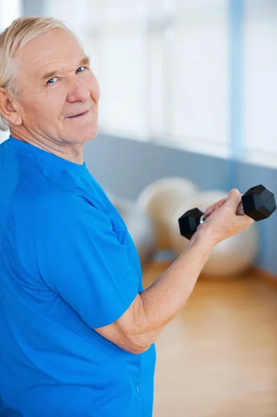 Senior man exercising with dumbbells