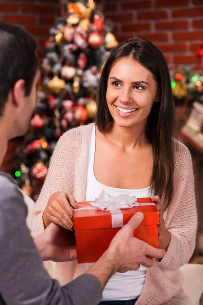 Man giving red gift box to his girlfriend