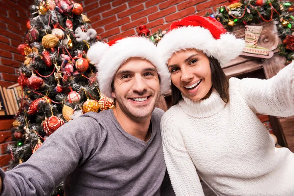 Loving couple making selfie on Christmas