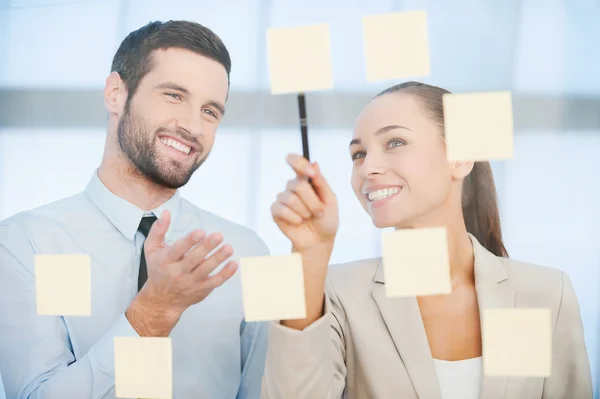 Business people pointing adhesive notes