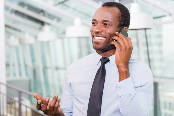 African man in shirt and tie talking on the mobile phone