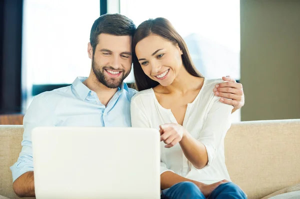 Loving couple  looking at laptop