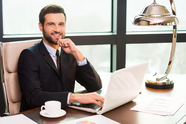 Man in suit sitting at working place