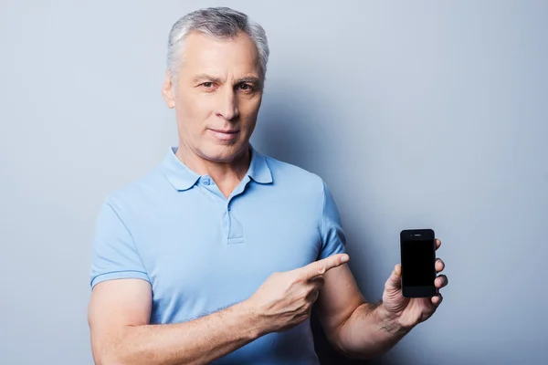 Senior man  showing new mobile phone