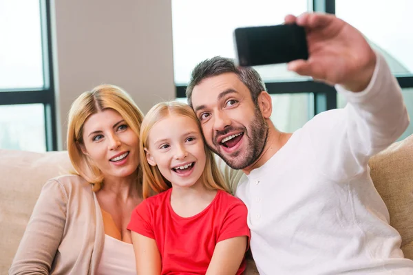 Happy family photographing them with smart phone