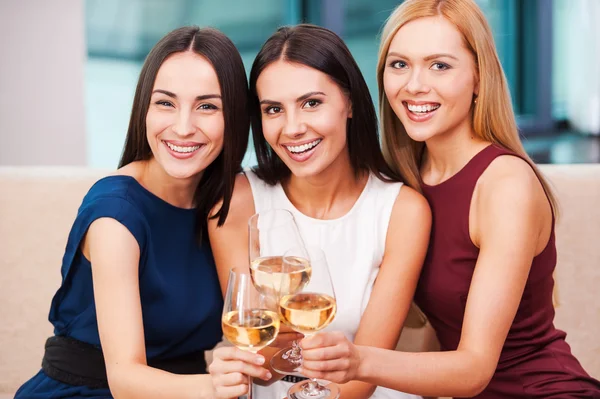 Women holding glasses with wine