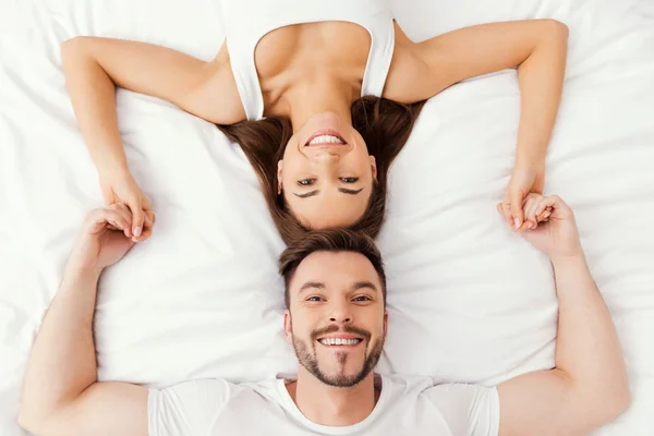 Loving couple lying in bed