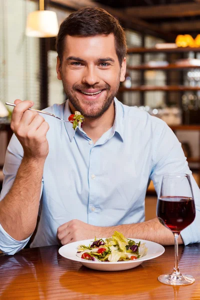 Man eating salad at  restaurant