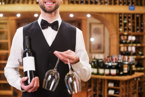 Man holding bottle and glasses