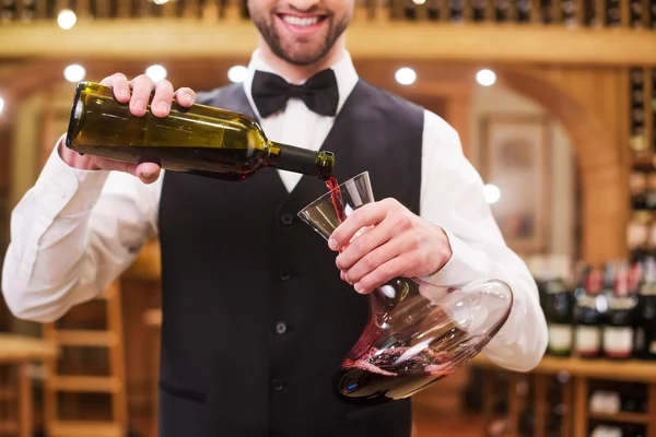 Man pouring red wine