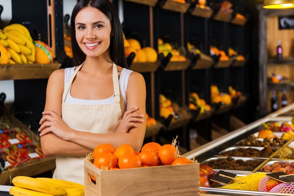 Smiling woman standing in grocery store
