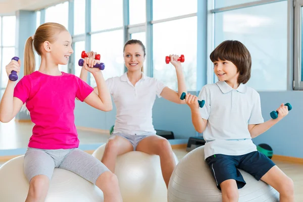 Mother and two children in health club